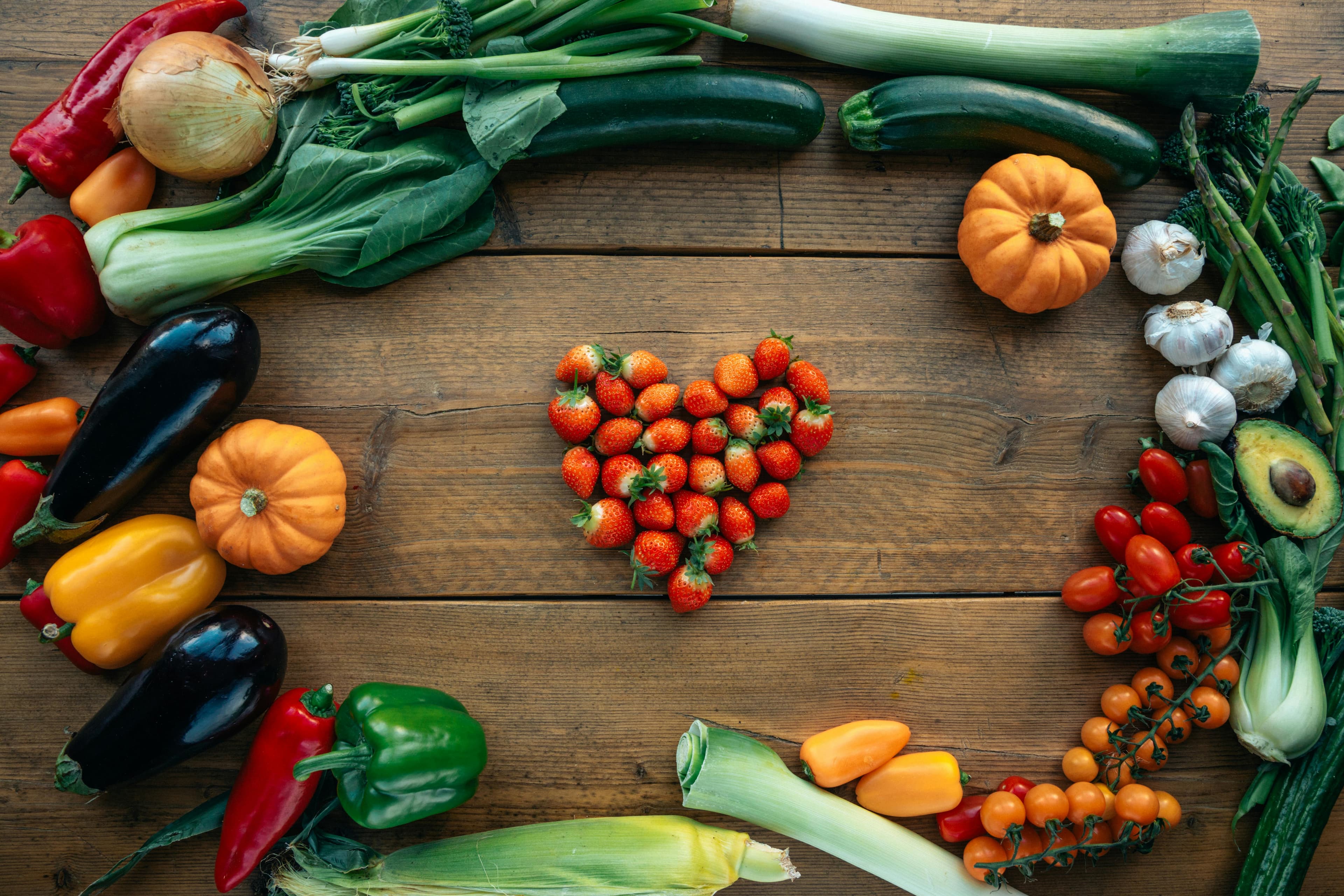 Fresh vegetables arranged in heart shape representing our love for quality ingredients